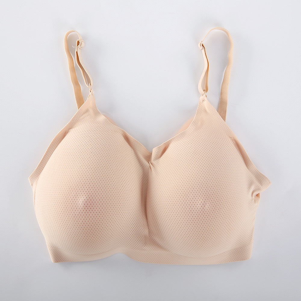 A beige seamless wireless bra with a textured, breathable mesh-like fabric, shown flat against a light gray background.