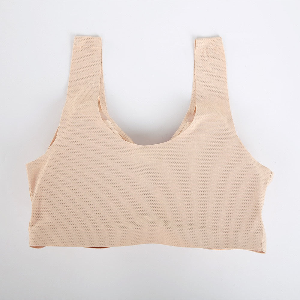 A beige seamless sports bra with a textured, breathable mesh-like fabric, laid flat against a clean white background.
