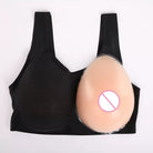 Black wireless bra with a beige silicone nipple cover applied to the right cup, shown on a plain white background.