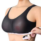 A close-up of a person wearing a black mesh underwire bra while measuring the band with a tape measure. A circular inset shows the tape measure in detail.