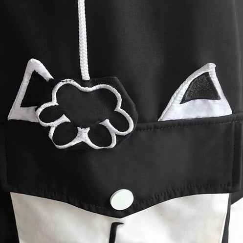 Black and white hoodie with cat ears and a knuckle design on a dark background