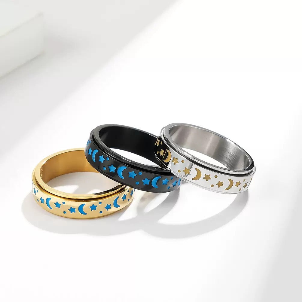 Three rings with star and moon designs on a white background