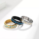 Three rings with star and moon designs on a white background