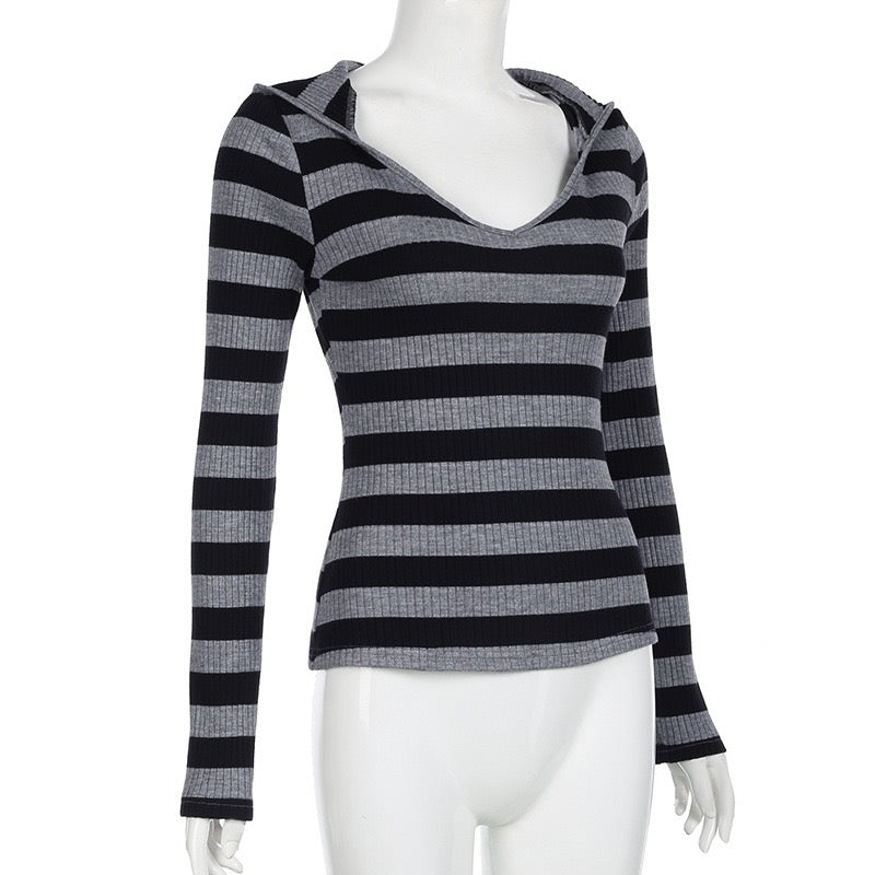 Black and gray striped long-sleeve top on a mannequin against a white background