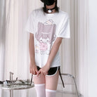 Person wearing a white t-shirt with a graphic design in a minimal indoor setting