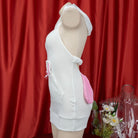 Mannequin wearing a white cute sleeveless bunny lingerie against a red curtain background