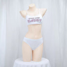 Mannequin wearing a white bra and panties set with text on a plain background