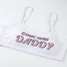 White crop top with pink text 'COME HERE DADDY' on a white background