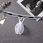 White lace choker with black 'SPORT' strap on a gray surface