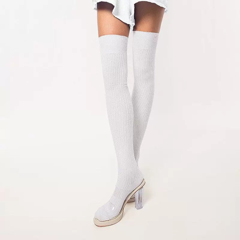 White thigh-high socks with clear high-heeled shoes on a white background