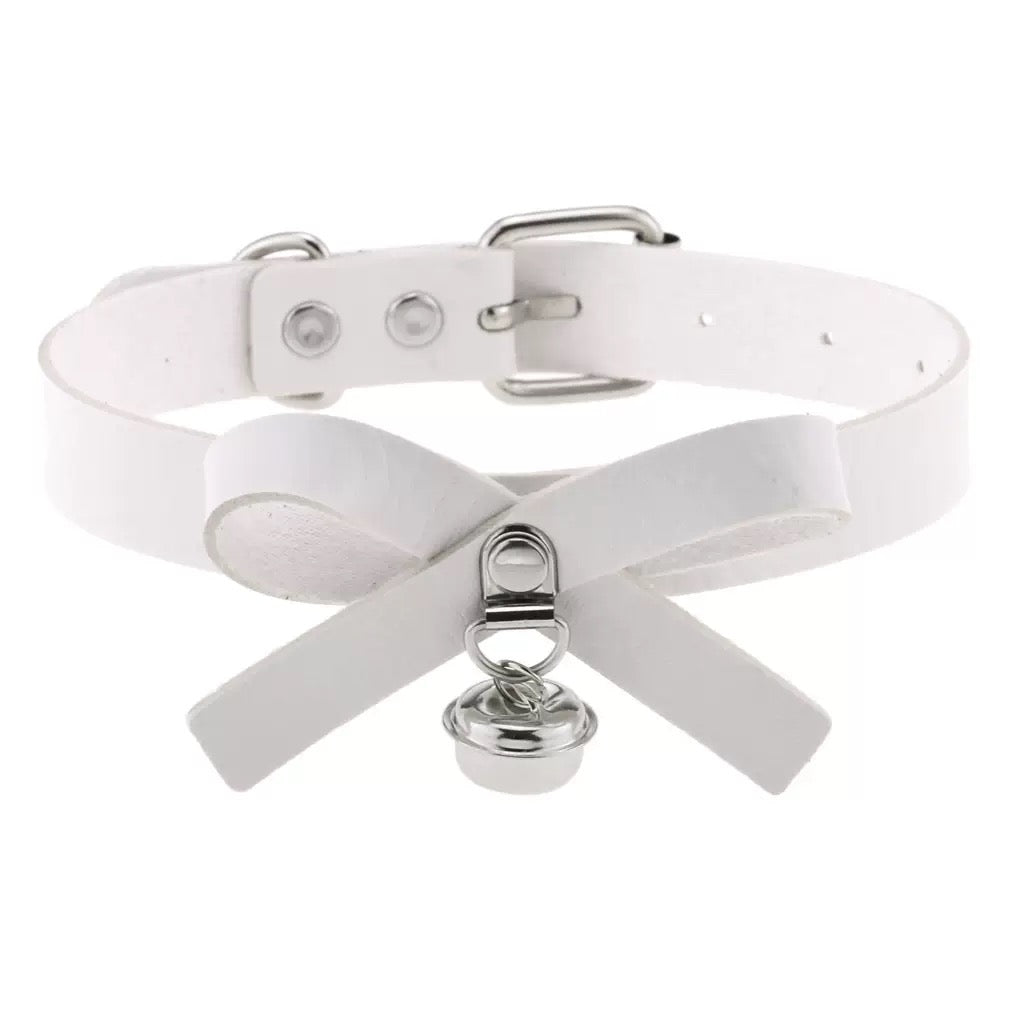 White leather choker with silver hardware and a bell on a white background