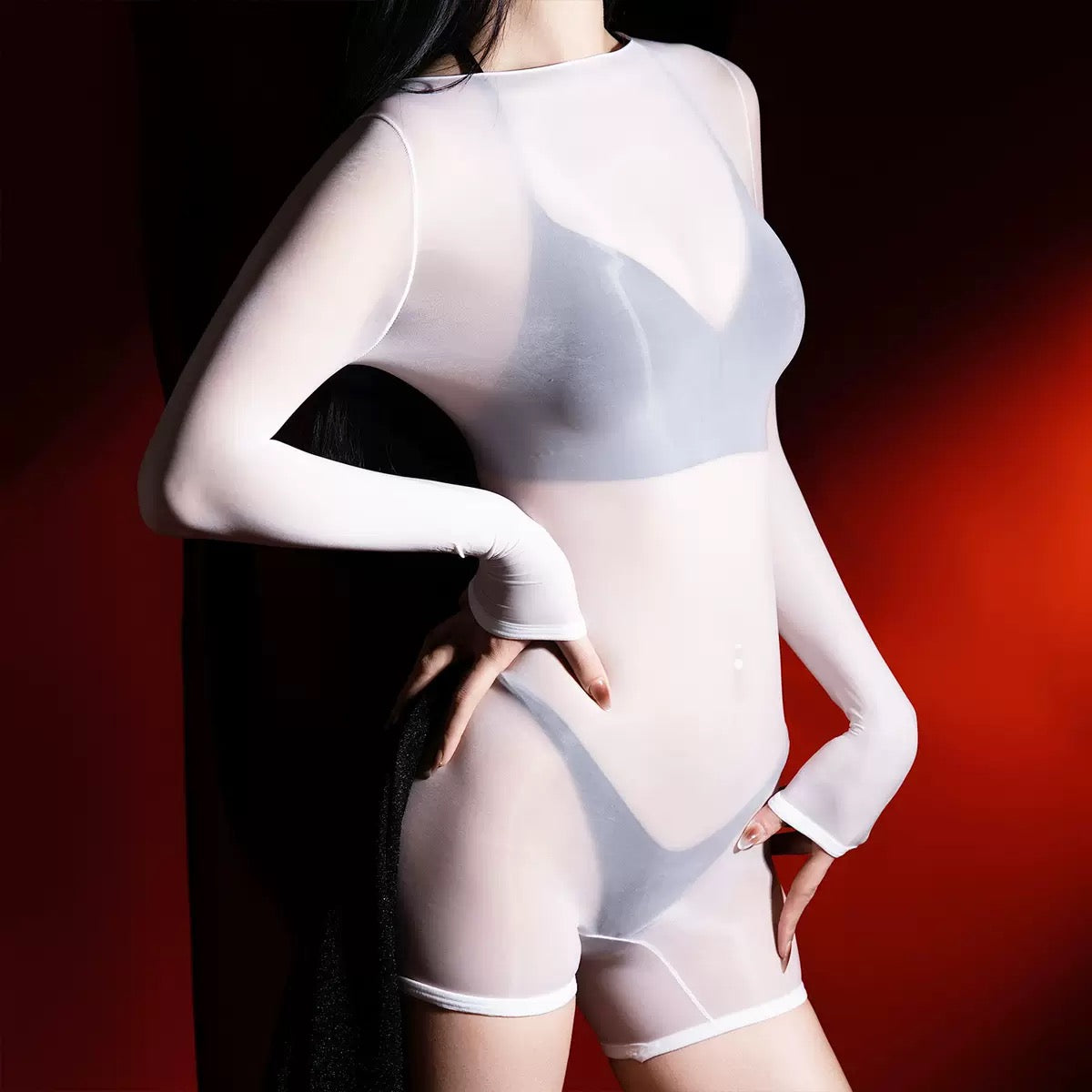 Person wearing a sheer white long sleeve body stocking romper