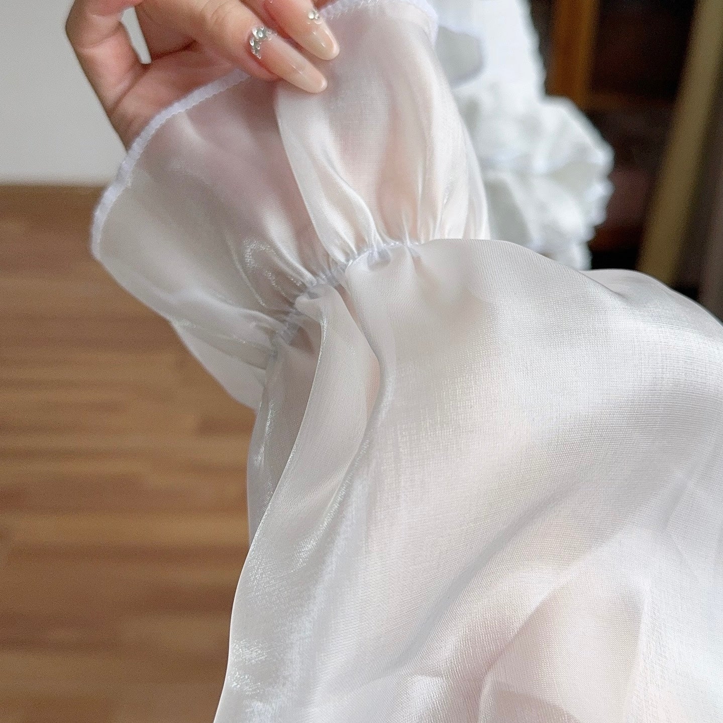 Close-up of a white sheer fabric with a blurred background
