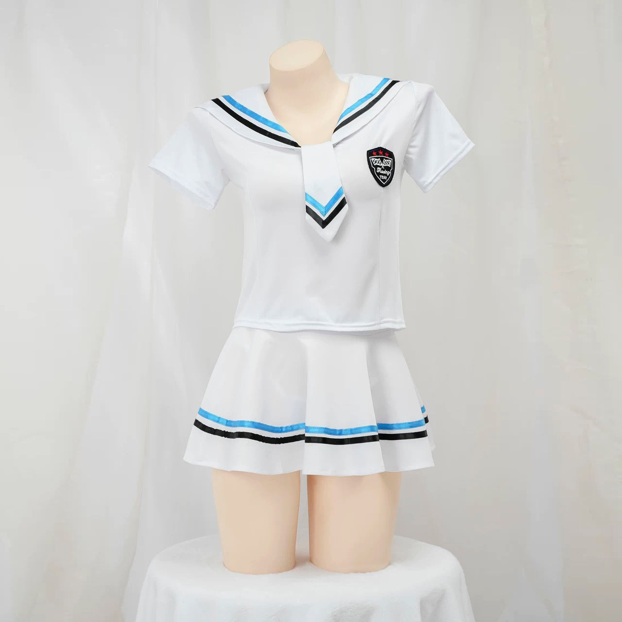 White sailor lingerie set with black and blue accents on a mannequin against a plain background