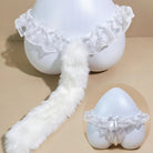 White faux-fur tail accessory with a ruffled lace waistband, displayed on a white mannequin against a beige studio background, with a circular inset showing a matching lace garter-style bottom.